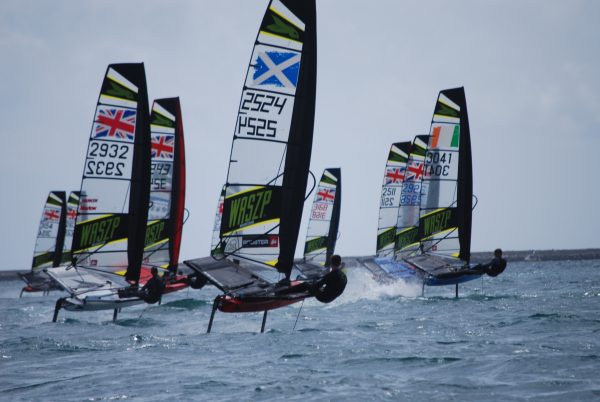 WASZP fleet at the UK Nationals foiling away from the camera ready for the WASZP Games WPNSA